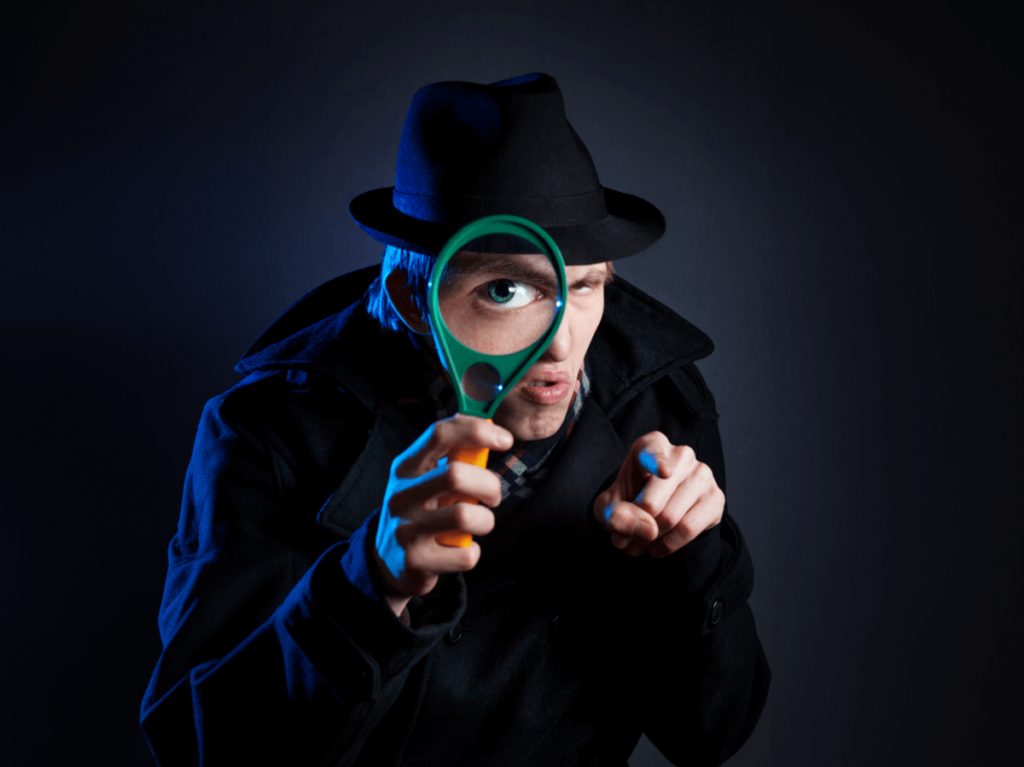 Detective intensely looking through a magnifying glass, focusing on details
